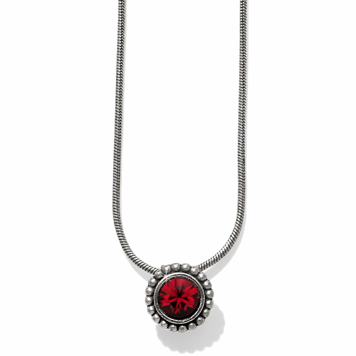 Brighton pendant necklace with red crystal centerpiece, silver-plated beaded frame, and snake chain on a white background