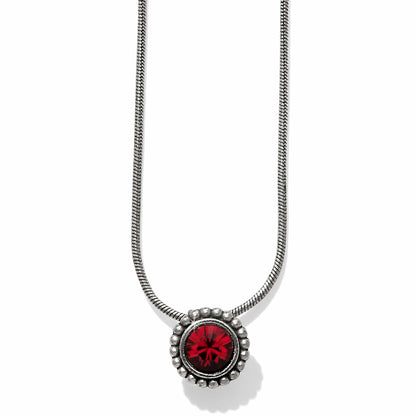 Brighton pendant necklace with red crystal centerpiece, silver-plated beaded frame, and snake chain on a white background