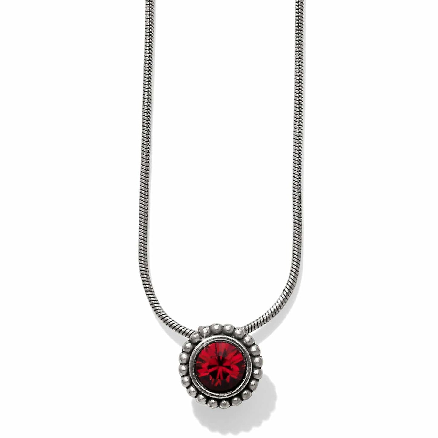 Brighton pendant necklace with red crystal centerpiece, silver-plated beaded frame, and snake chain on a white background