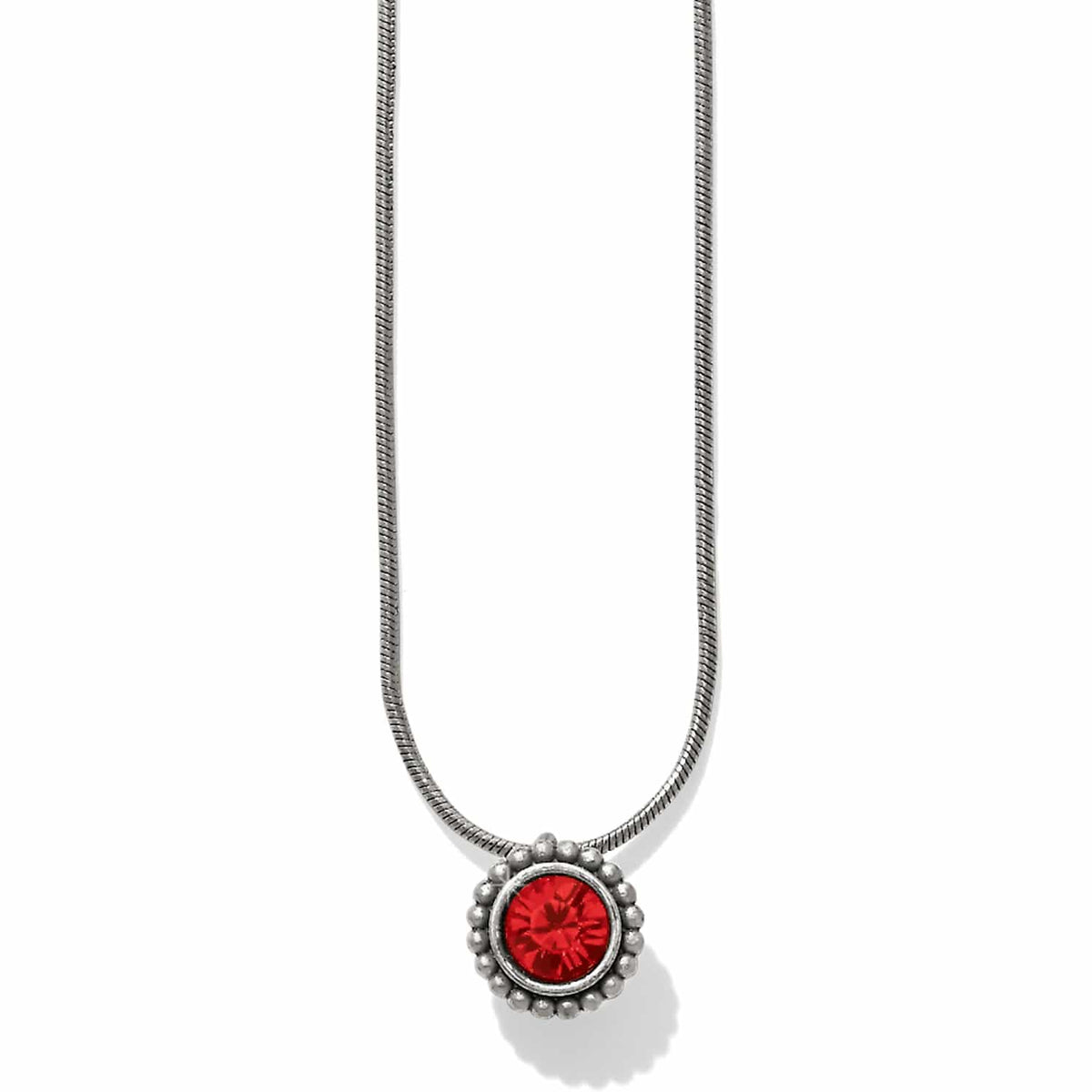 Brighton pendant necklace with red crystal center and beaded silver-plated frame on snake chain on a white background