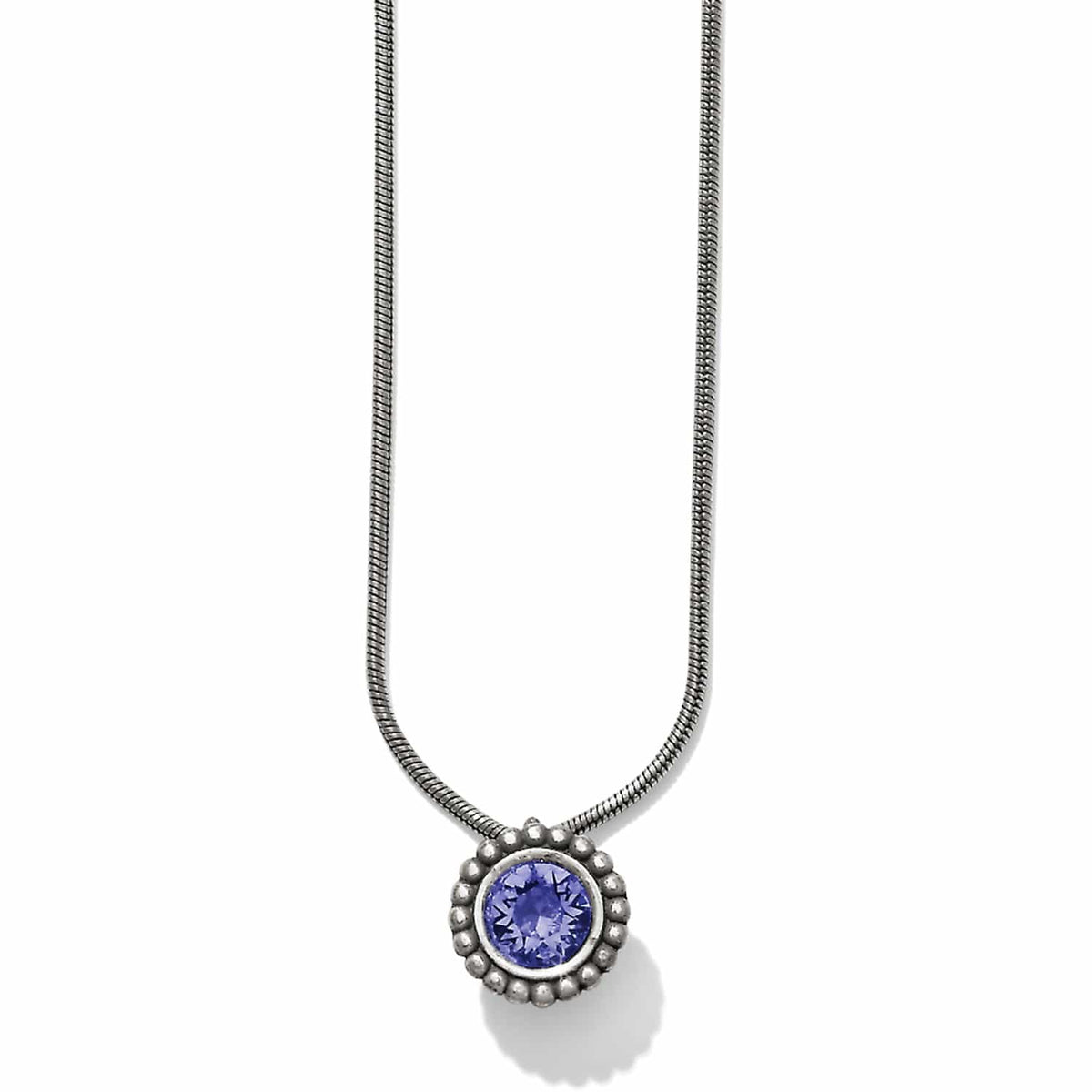 Brighton pendant necklace with round purple crystal in beaded silver-plated setting on snake chain on a white background