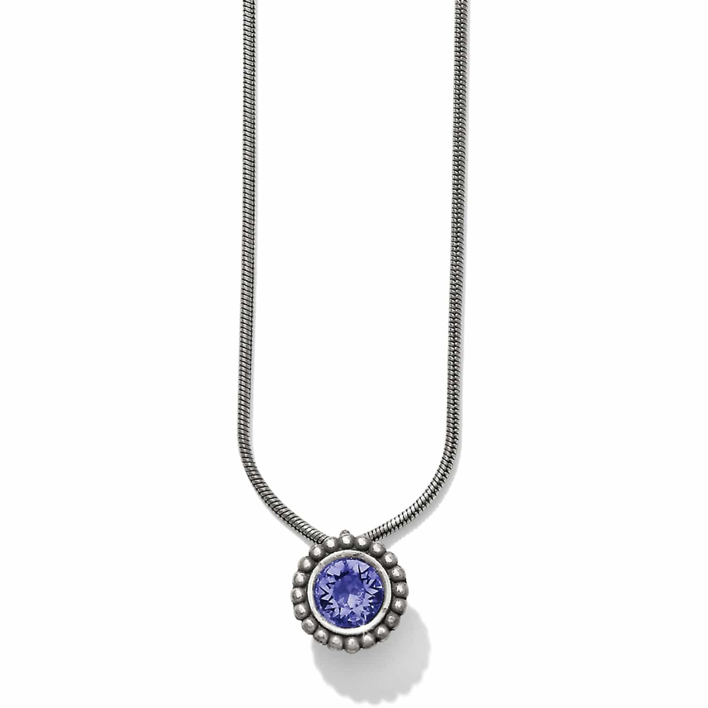 Brighton pendant necklace with round purple crystal in beaded silver-plated setting on snake chain on a white background