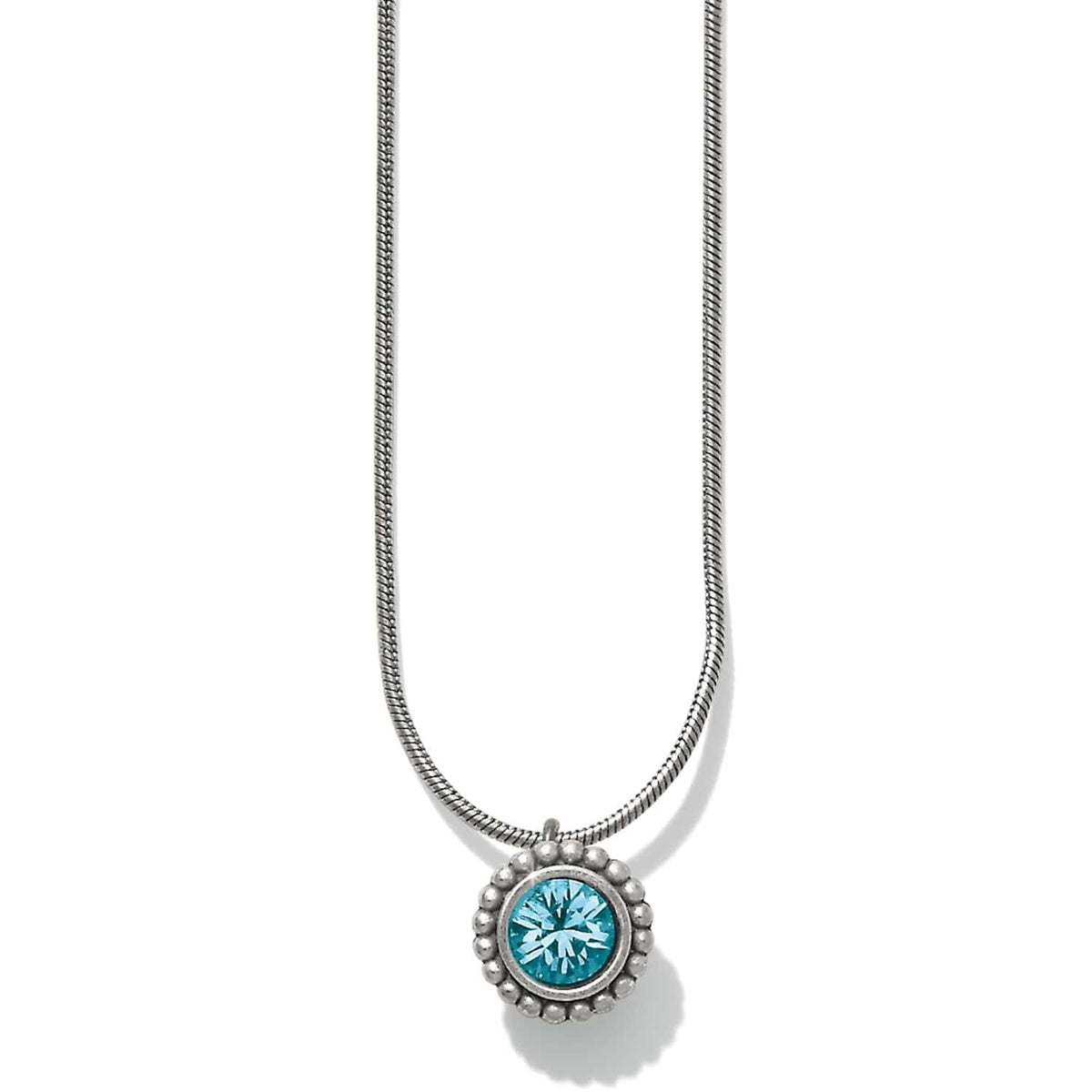 Brighton pendant necklace with round blue crystal and silver-plated beaded frame on snake chain on a white background