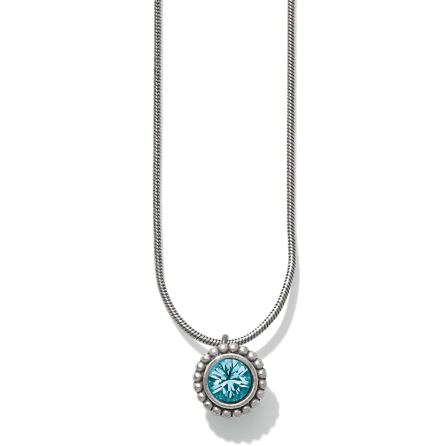 Brighton pendant necklace with round blue crystal and silver-plated beaded frame on snake chain on a white background