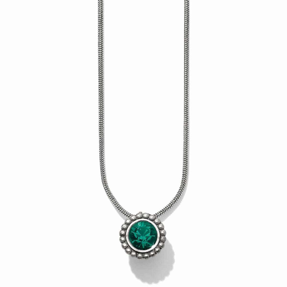 Brighton pendant necklace with green crystal center and beaded silver-plated frame on snake chain on a white background