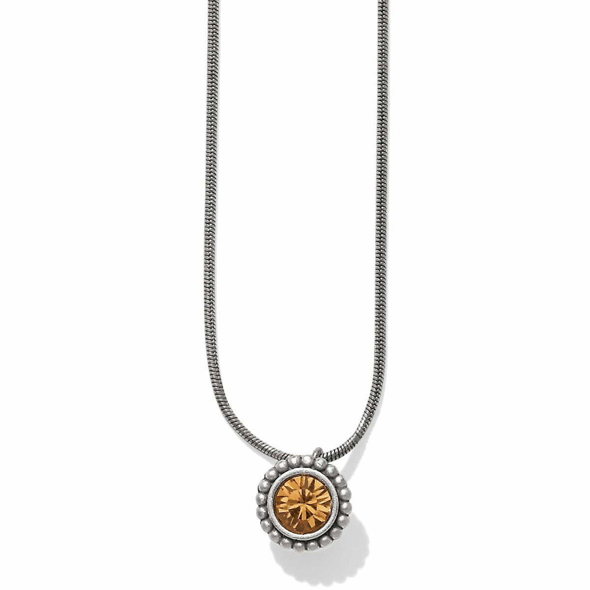 Brighton pendant necklace with round amber crystal and beaded silver-plated frame on a snake chain on a white background