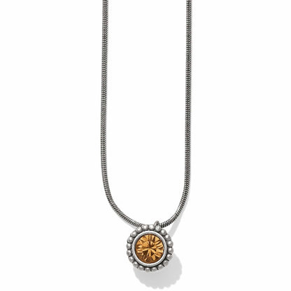 Brighton pendant necklace with round amber crystal and beaded silver-plated frame on a snake chain on a white background