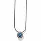 Brighton pendant necklace with blue crystal centerpiece, beaded silver-plated frame, and snake chain on a white background