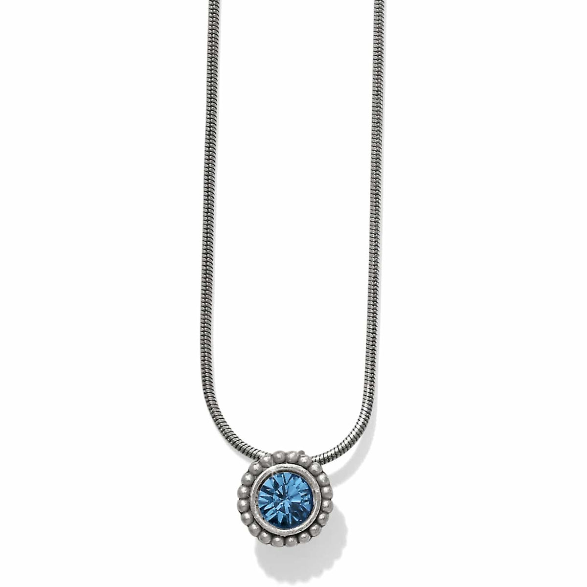 Brighton pendant necklace with blue crystal centerpiece, beaded silver-plated frame, and snake chain on a white background