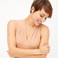 Model wearing a Brighton silver and gold cross pendant necklace with coordinating Brighton earrings and bangle bracelet