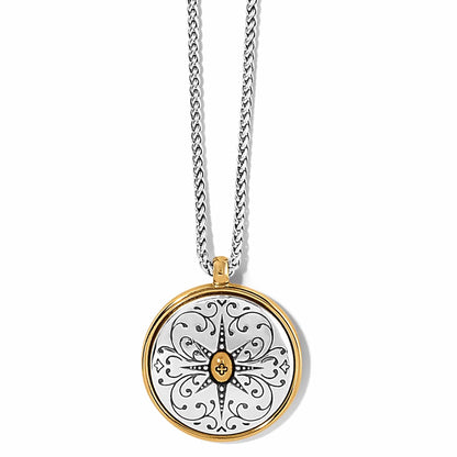 Brighton pendant necklace with two-tone round medallion featuring engraved starburst and scroll design on a white background