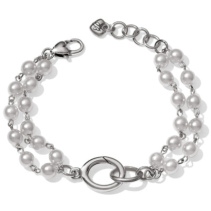 Brighton bracelet with double strand of white pearls, silver-plated interlocking ring centerpiece, and lobster clasp on a white background