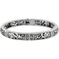 Brighton hinged bangle bracelet with silver-plated openwork scroll design and crystal accents on a white background
