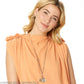 Model wearing a Brighton long silver-plated beaded necklace with crystal accents and assorted charm pendants