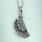 Brighton wing pendant necklace with silver-tone feather detail and crystal accents on a pale mint background