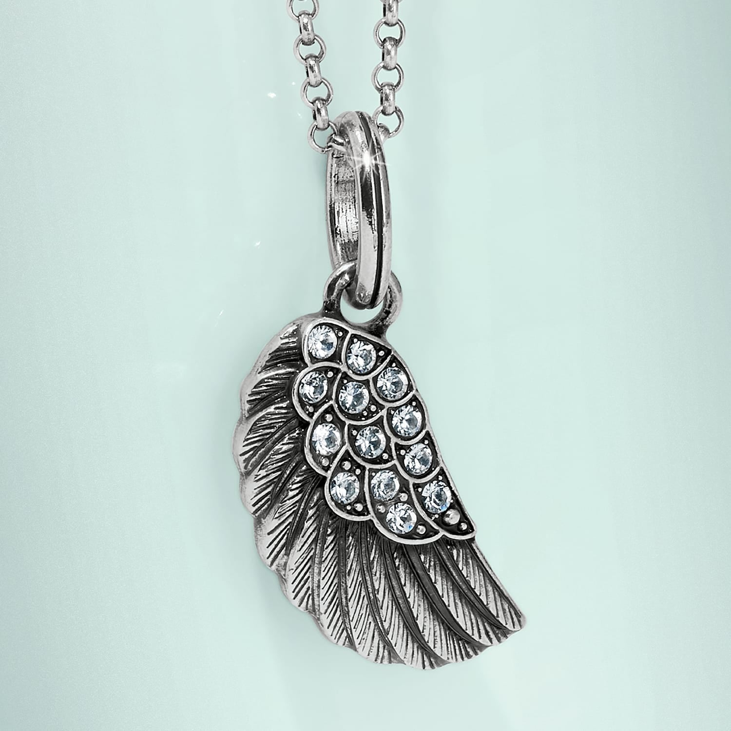 Brighton wing pendant necklace with silver-tone feather detail and crystal accents on a pale mint background