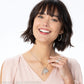 Model wearing a Brighton silver-plated charm necklace with wing, crystal, and blue medallion charms and coordinating Brighton accessories