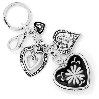 Brighton keychain with silver-plated heart charms and black enamel floral medallion on a white background