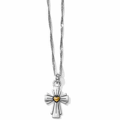 Brighton pendant necklace with two-tone cross, gold heart center, and crystal-accented bail on a white background