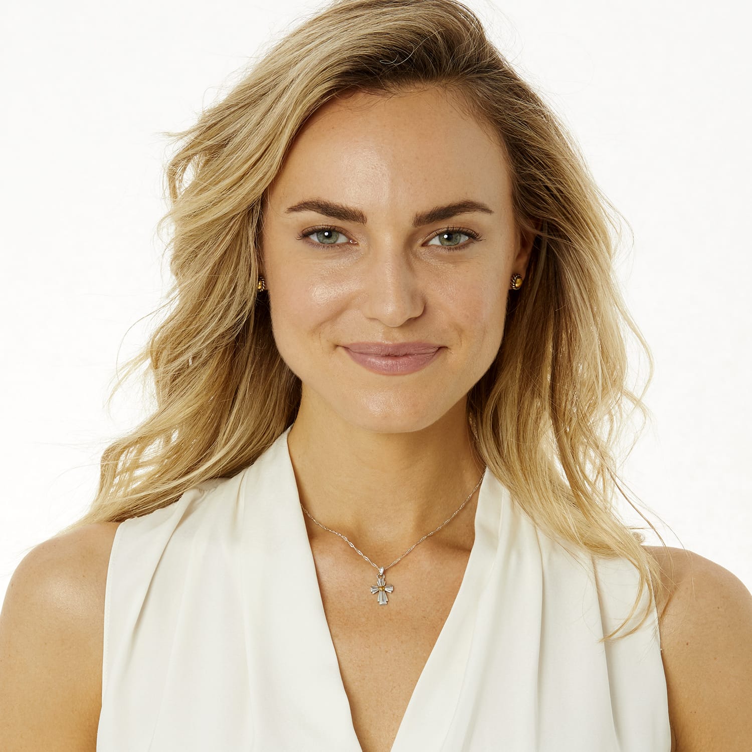 Model wearing a Brighton two-tone cross pendant necklace with crystal accents paired with matching gold-tone stud earrings