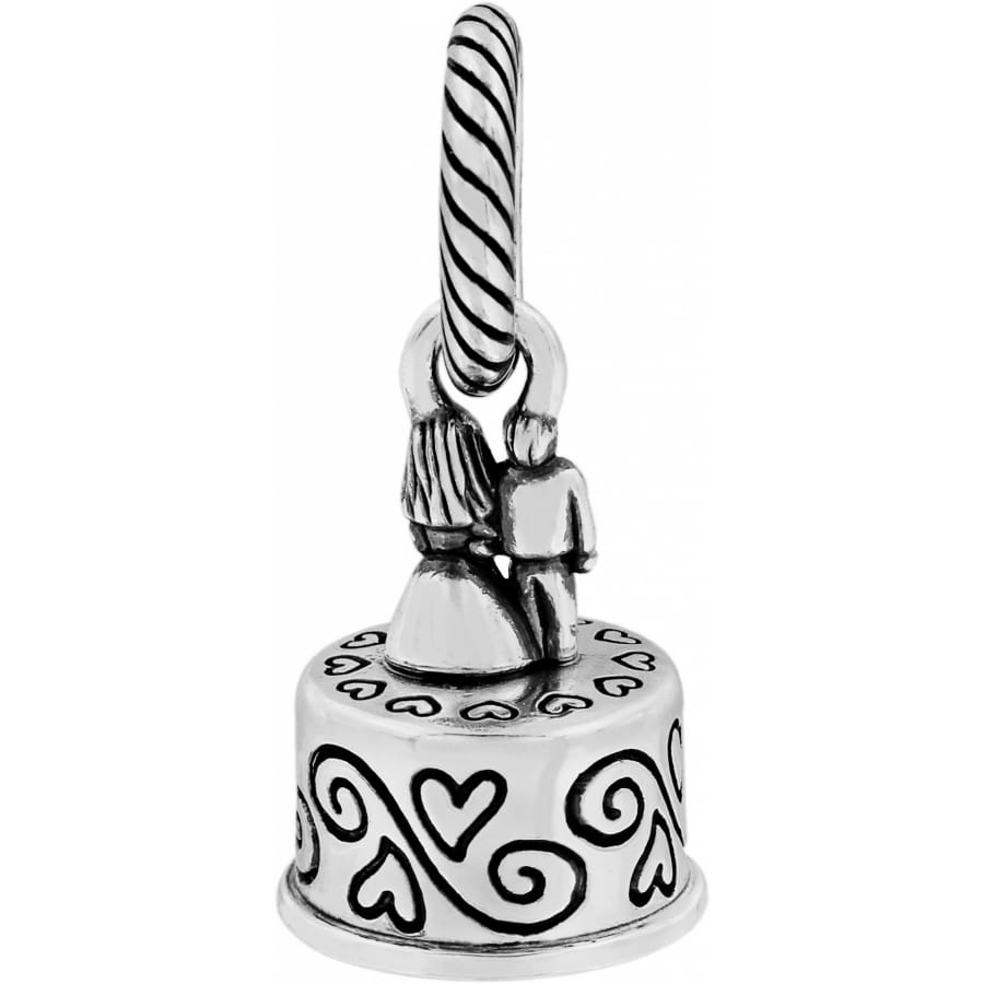 Brighton silver-plated wedding cake charm with bride and groom figures and scroll heart detailing on a white background