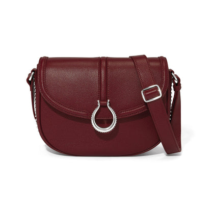 Brighton crossbody handbag in burgundy leather with silver-tone horseshoe ring closure and adjustable strap on a white background
