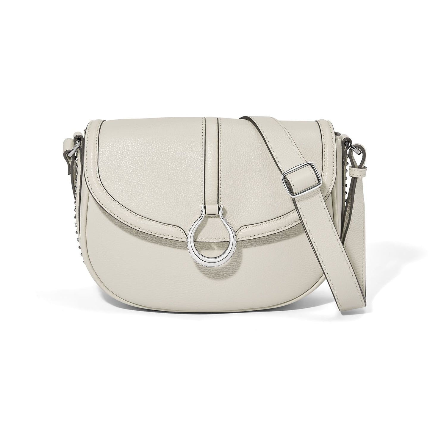 Brighton crossbody saddle handbag in cream leather with silver-tone ring accent and adjustable strap on a white background