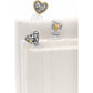 Brighton two-tone heart bookmarks with silver and gold-tone detailing clipped onto white fabric-covered books on a white background
