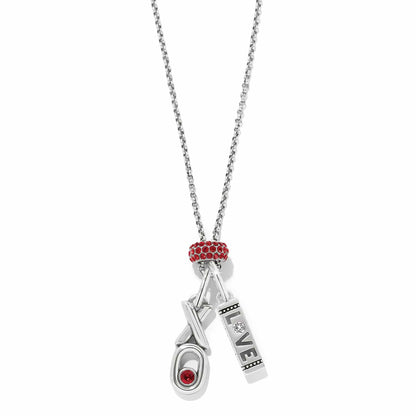 Brighton silver-plated charm necklace with red crystal bead, love bar charm, and XO charm on a white background
