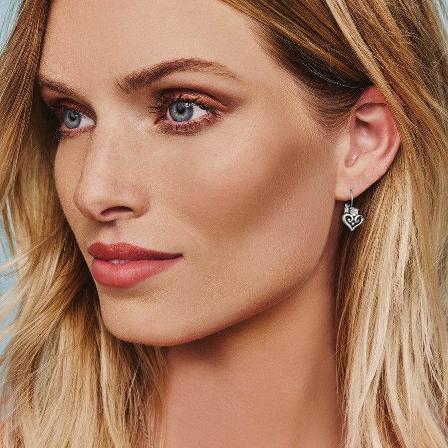 Close up of model wearing Alcazar Heart Leverback Earrings