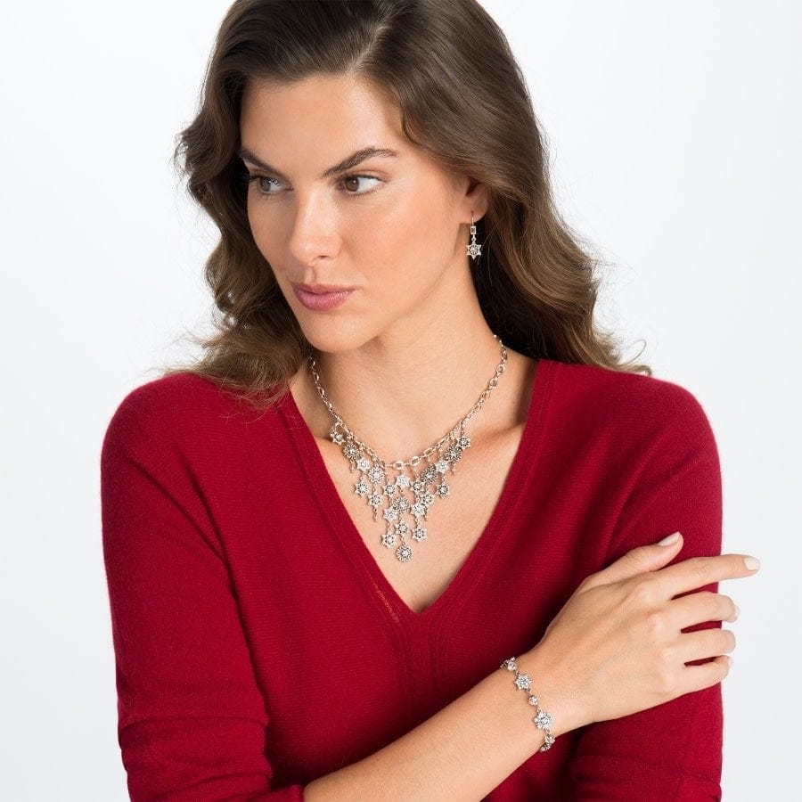 Model wearing a Brighton silver-plated crystal statement necklace with coordinating Brighton earrings and bracelet accessories