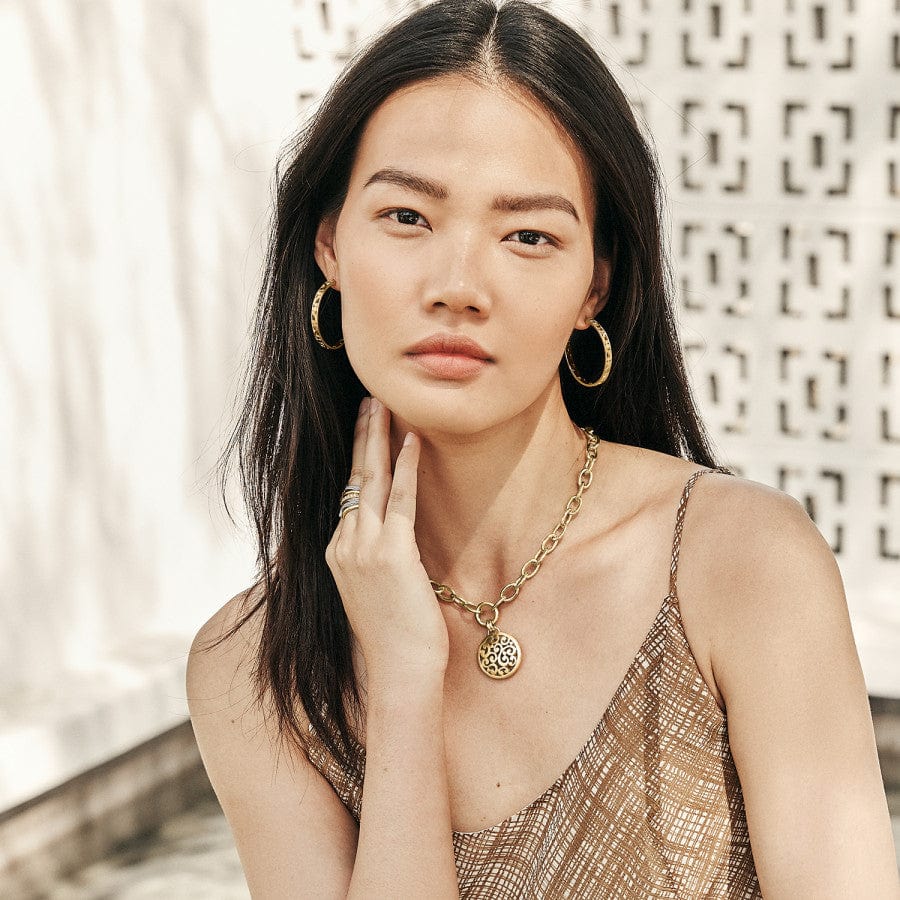 Modeling wearing Gold Contempo Medium Hoop Earrings