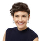 Model wearing Contempo Medium Hoop Earrings in silver looking to the left and smiling