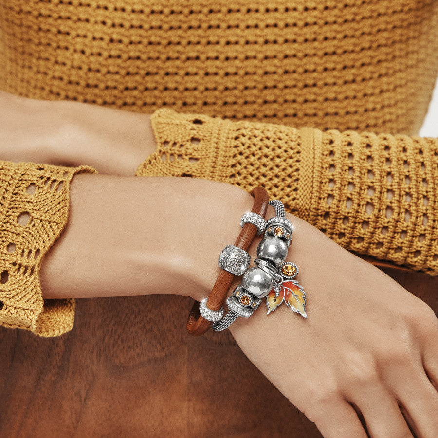 Premium Photo | Closeup female hands with bracelet and rings with yellow autumn  leaf on the knees