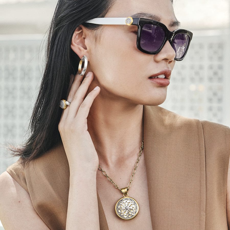 Model wearing Ferrara Two Tone Luce Large Pendant Necklace with matching ring, earring and sunglasses