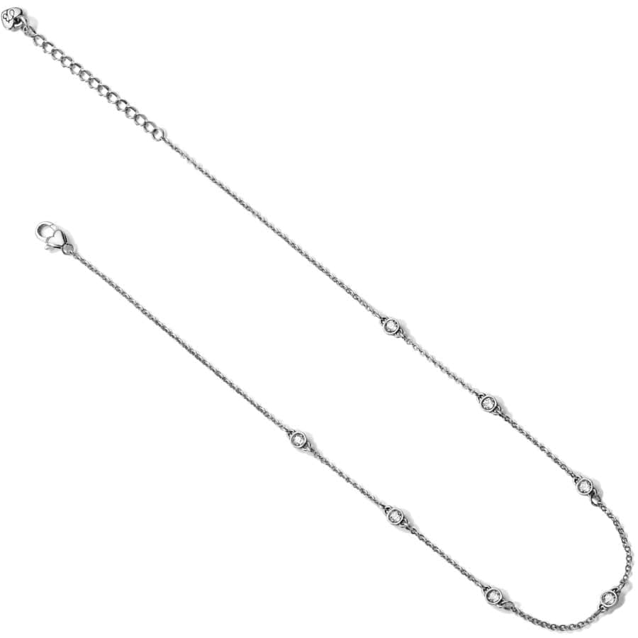A silver necklace the Illumina Petite Collar Necklace has a delicate chain and symmetrically placed decorative elements, displayed against a plain background.