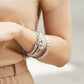 Model in tan wearing Interlok Hinged Bangle