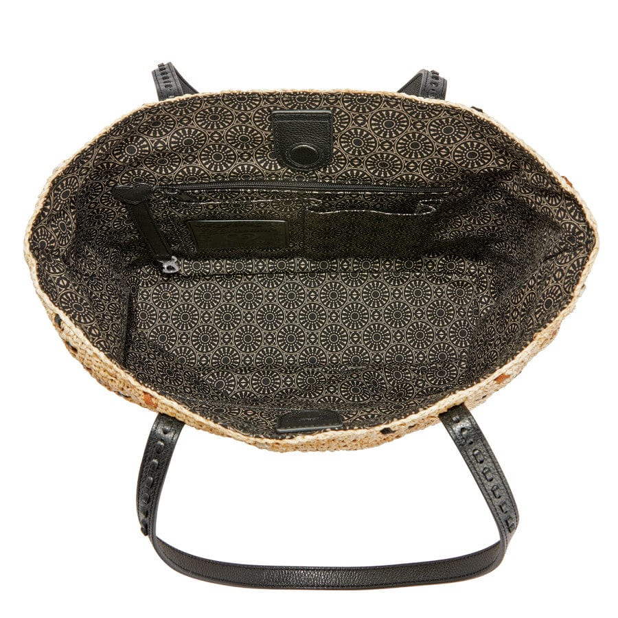 Inside view of Kennis Straw Tote, showing the spacious compartment and fabric lining with floral pattern
