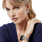 Woman wearing Meridian Tempo Apple Watch Band with matching earrings looking at you