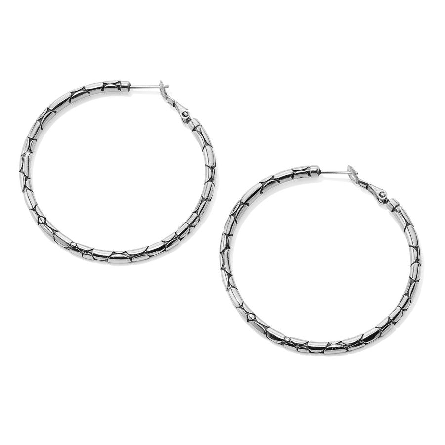 Pebble Large Hoop Earrings side view, silver hoop earrings with a bamboo-style design rest against a white background.