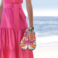 Woman wearing Pretty Tough Apple Watch Band holding sandals in pink on a beach