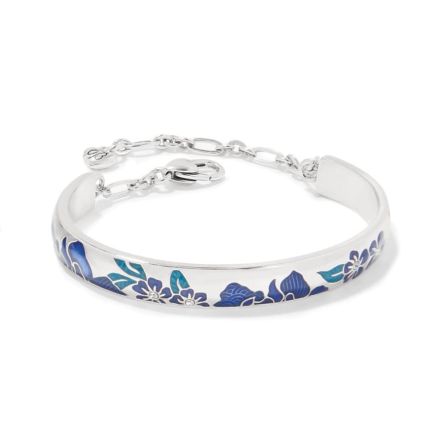 A silver-colored Terra Bar Bracelet bangle with blue floral pattern engravings lying against a white background. It has a chain and clasp for secure fastening.