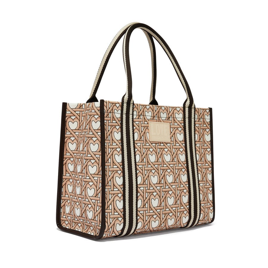 Side view of Woven Hearts Canvas Carry All, featuring the heart-patterned canvas and sturdy handles